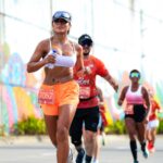 Group of diverse runners in a vibrant outdoor marathon, showcasing determination and fitness.